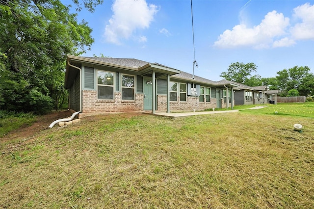 324 W Munson St Unit 326, Denison, TX 75020 - back of house featuring brick siding and a yard