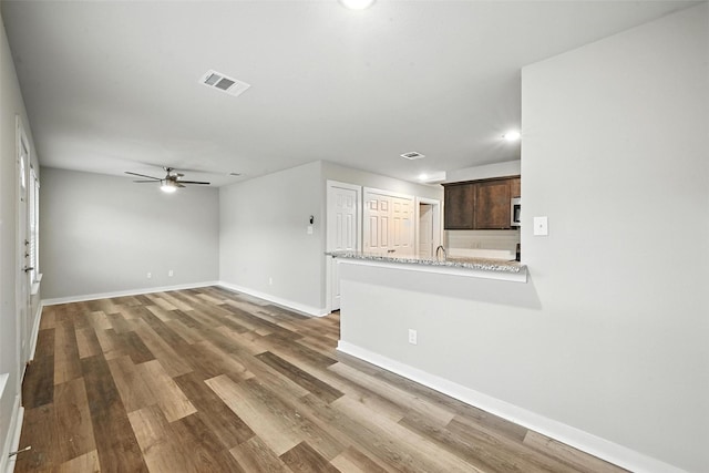 324 W Munson St Unit 326, Denison, TX 75020 - unfurnished living room featuring ceiling fan, wood finished floors, and recessed lighting