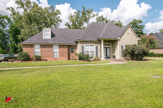 1859 Sparrow Rdg, Haughton, LA 71037 - view of front of home featuring french doors, a shingled roof, a front yard, brick siding, and stucco siding