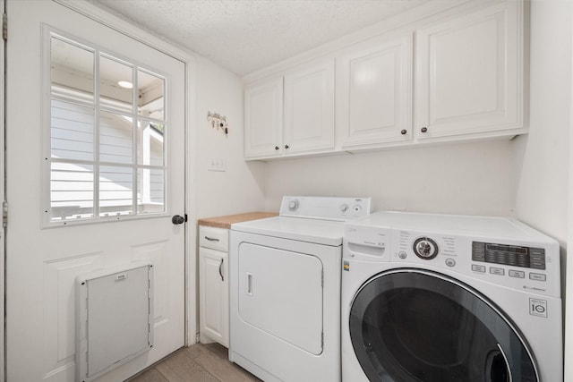 7720 Angelina Dr, Athens, TX 75752 - washroom featuring washing machine and dryer, cabinet space, a textured ceiling, and light wood-type flooring