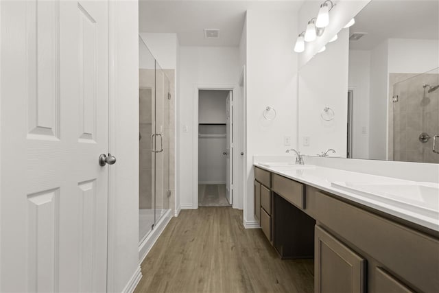 469 Silent Pond, Lavon, TX 75166 - bathroom with a stall shower, wood finished floors, double vanity, and a spacious closet