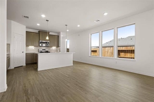 469 Silent Pond, Lavon, TX 75166 - kitchen with appliances with stainless steel finishes, plenty of natural light, wood finished floors, tasteful backsplash, and recessed lighting