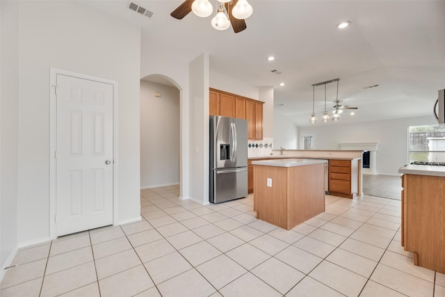 1647 Ash Ln, Corinth, TX 76210 - kitchen featuring stainless steel fridge, a ceiling fan, arched walkways, light countertops, and recessed lighting