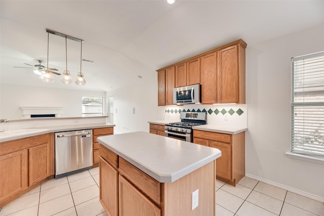 1647 Ash Ln, Corinth, TX 76210 - kitchen with stainless steel appliances, a ceiling fan, decorative backsplash, a fireplace, and light tile patterned floors