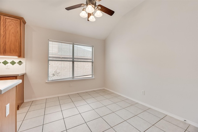 1647 Ash Ln, Corinth, TX 76210 - unfurnished dining area with vaulted ceiling, ceiling fan, and light tile patterned floors