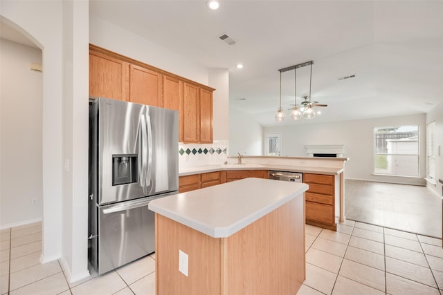 1647 Ash Ln, Corinth, TX 76210 - kitchen with stainless steel appliances, a peninsula, arched walkways, light tile patterned flooring, and light countertops