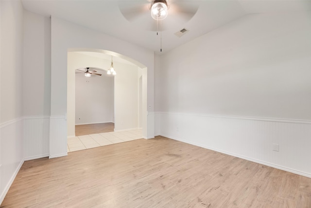 1647 Ash Ln, Corinth, TX 76210 - empty room featuring a ceiling fan, arched walkways, wood finished floors, and lofted ceiling