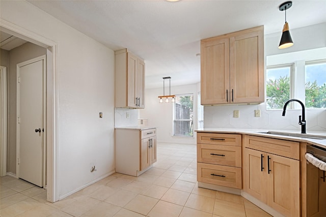 2217 Cedar Cir, Carrollton, TX 75006 - kitchen with light brown cabinets, stainless steel dishwasher, light countertops, and backsplash