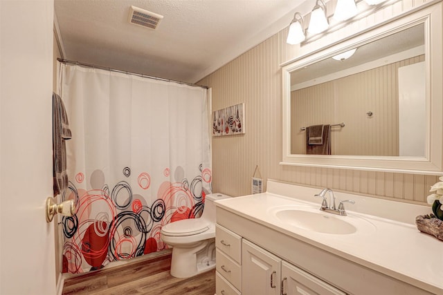 4018 Linda Ct, Granbury, TX 76048 - full bathroom with wood finished floors, vanity, a shower with shower curtain, and a textured ceiling