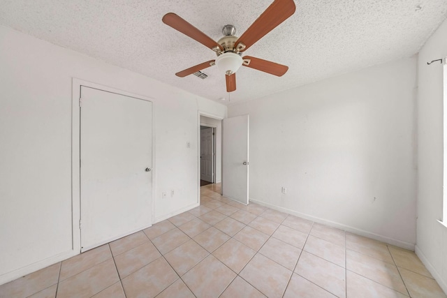 101 Arrowhead St, Fort Worth, TX 76108 - unfurnished bedroom featuring light tile patterned floors, a textured ceiling, and a ceiling fan