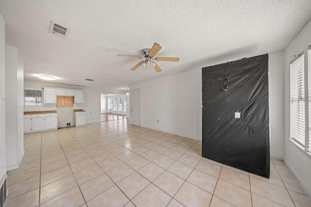 101 Arrowhead St, Fort Worth, TX 76108 - unfurnished living room featuring ceiling fan, a textured ceiling, and light tile patterned floors