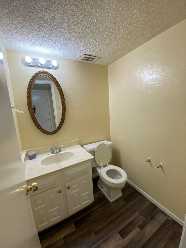 376 Valley Park Dr, Garland, TX 75043 - bathroom featuring wood finished floors, vanity, and a textured ceiling