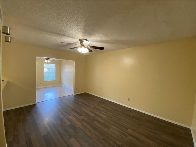 376 Valley Park Dr, Garland, TX 75043 - unfurnished room featuring a textured ceiling, dark wood-type flooring, and a ceiling fan