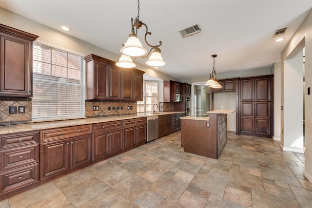 4105 Williams Ct, Grapevine, TX 76051 - kitchen with stainless steel appliances, backsplash, light stone finish flooring, pendant lighting, and recessed lighting