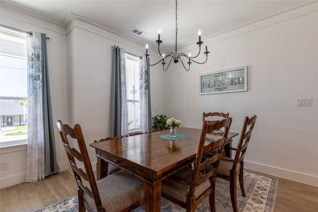 5523 Firewood Trl, Granbury, TX 76048 - dining room featuring light wood-style floors, a chandelier, and ornamental molding