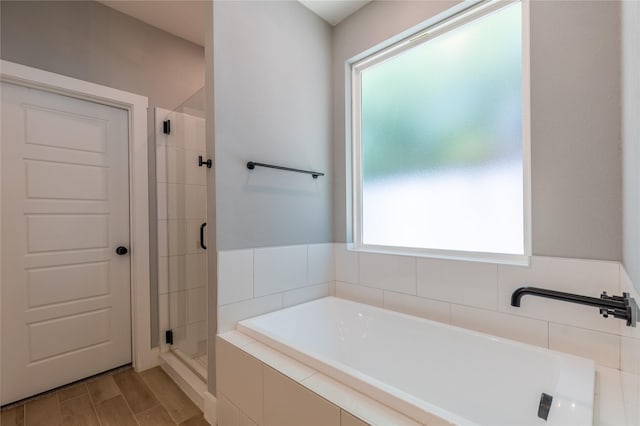 5523 Firewood Trl, Granbury, TX 76048 - full bathroom with plenty of natural light, a garden tub, a shower stall, and wood finished floors