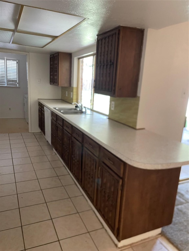 1505 Windy Meadow Dr, Plano, TX 75023 - kitchen with white dishwasher, plenty of natural light, light countertops, and light tile patterned floors