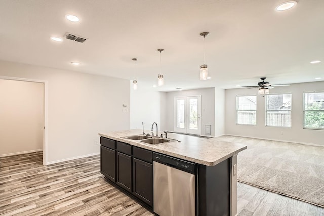 2020 Sun Star Dr, Haslet, TX 76052 - kitchen featuring dishwasher, open floor plan, light countertops, light wood finished floors, and an island with sink