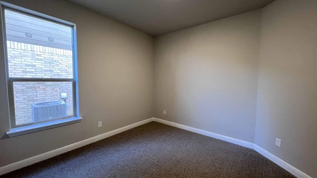 1821 Brindle St, Northlake, TX 76247 - spare room featuring dark carpet and baseboards