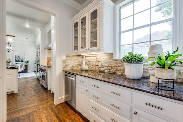 4421 Caruth Blvd, Dallas, TX 75225 - kitchen featuring ornamental molding, white cabinets, oven, glass insert cabinets, and backsplash