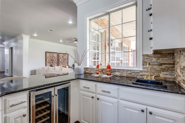 4421 Caruth Blvd, Dallas, TX 75225 - indoor wet bar featuring beverage cooler, crown molding, backsplash, a ceiling fan, and recessed lighting