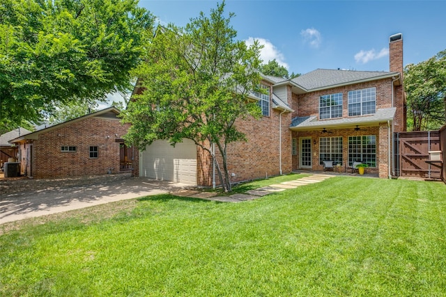 4421 Caruth Blvd, Dallas, TX 75225 - back of house featuring driveway, a chimney, a ceiling fan, brick siding, and a gate
