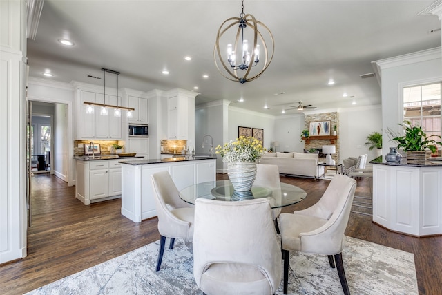 4421 Caruth Blvd, Dallas, TX 75225 - dining room featuring recessed lighting, ornamental molding, dark wood-style flooring, a ceiling fan, and a chandelier