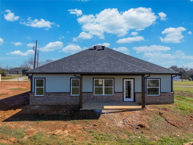 148 Crescent St, Bullard, TX 75757 - view of front of house featuring brick siding, roof with shingles, and a patio area
