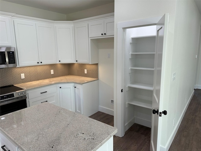 204 Ella St, Whitesboro, TX 76273 - kitchen with stainless steel appliances, dark wood-type flooring, white cabinetry, and backsplash