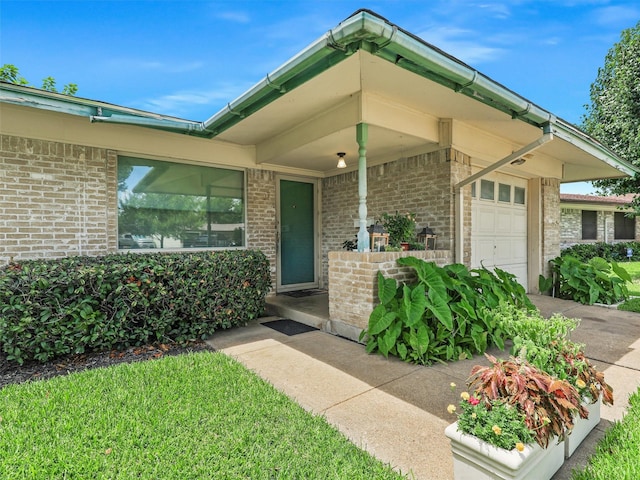 2407 Towerwood Dr, Carrollton, TX 75006 - view of exterior entry featuring brick siding and a garage