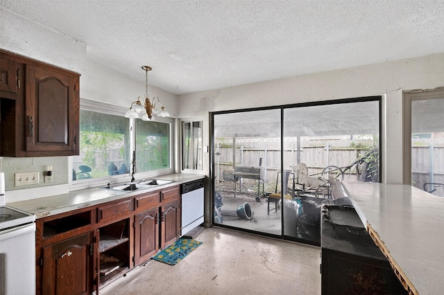 1801 Plantation Rd, Garland, TX 75044 - kitchen featuring white appliances, a textured ceiling, a chandelier, light countertops, and decorative light fixtures