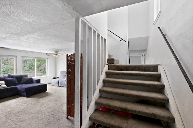 1801 Plantation Rd, Garland, TX 75044 - staircase featuring a textured ceiling, carpet, and a ceiling fan