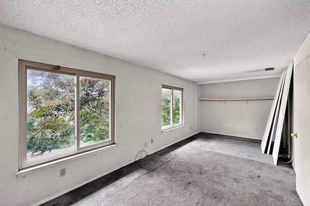 1801 Plantation Rd, Garland, TX 75044 - unfurnished bedroom with a textured ceiling, carpet floors, and a closet