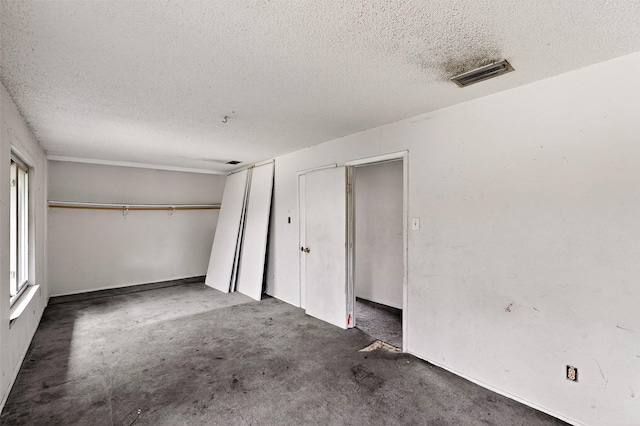 1801 Plantation Rd, Garland, TX 75044 - unfurnished bedroom with a textured ceiling and a closet