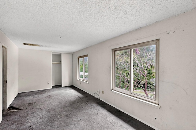1801 Plantation Rd, Garland, TX 75044 - unfurnished bedroom featuring a textured ceiling and a closet