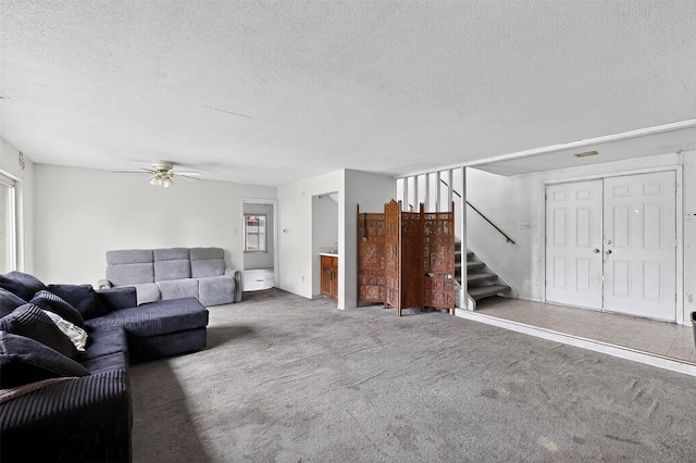 1801 Plantation Rd, Garland, TX 75044 - living area featuring a textured ceiling, carpet floors, stairs, and ceiling fan