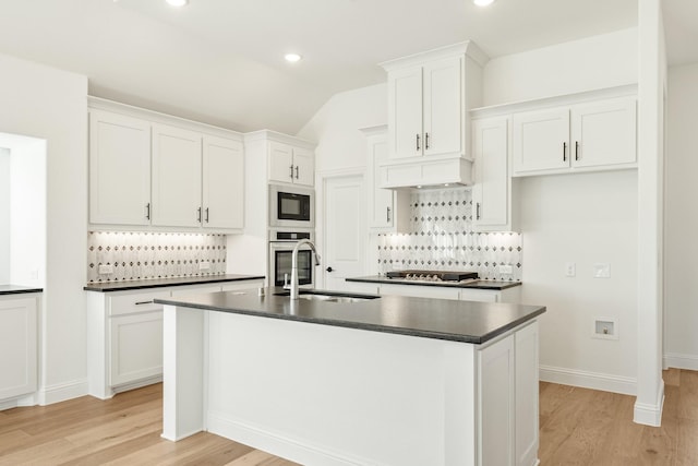 2500 Fischer Ln, Mansfield, TX 76063 - kitchen featuring dark countertops, stainless steel appliances, light wood-style flooring, tasteful backsplash, and recessed lighting