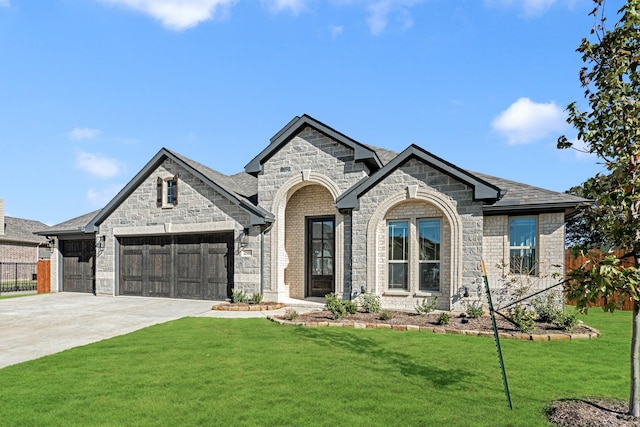 2500 Fischer Ln, Mansfield, TX 76063 - french country inspired facade featuring a garage, stone siding, driveway, a front yard, and brick siding