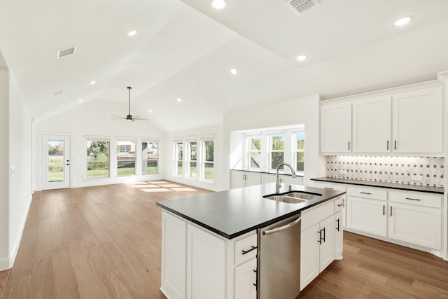 2500 Fischer Ln, Mansfield, TX 76063 - kitchen featuring stainless steel dishwasher, dark countertops, a ceiling fan, a kitchen island with sink, and open floor plan