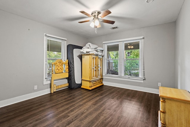 1601 W Bond St, Denison, TX 75020 - unfurnished bedroom featuring dark wood finished floors and ceiling fan