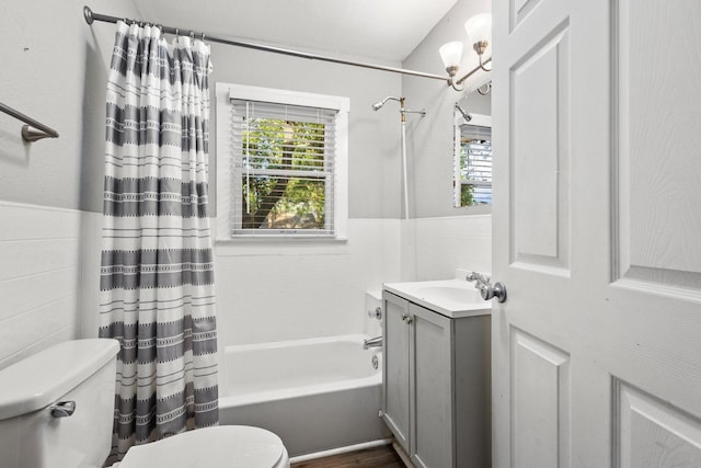 1601 W Bond St, Denison, TX 75020 - full bathroom featuring shower / tub combo, vanity, healthy amount of natural light, wainscoting, and tile walls