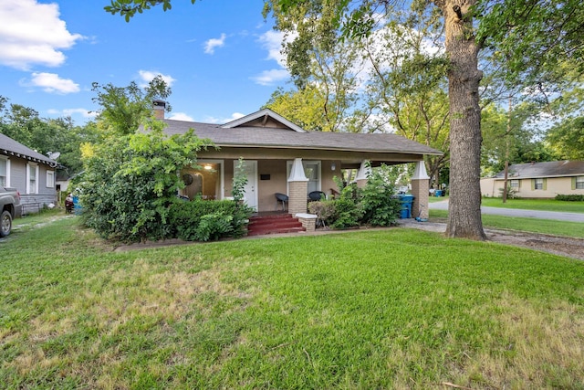 1601 W Bond St, Denison, TX 75020 - view of front of house with a porch, a front lawn, a chimney, and roof with shingles