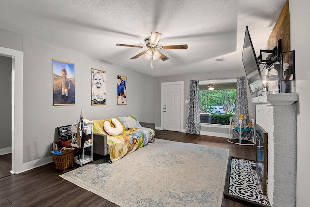 1601 W Bond St, Denison, TX 75020 - living room featuring a ceiling fan, wood finished floors, and a textured ceiling