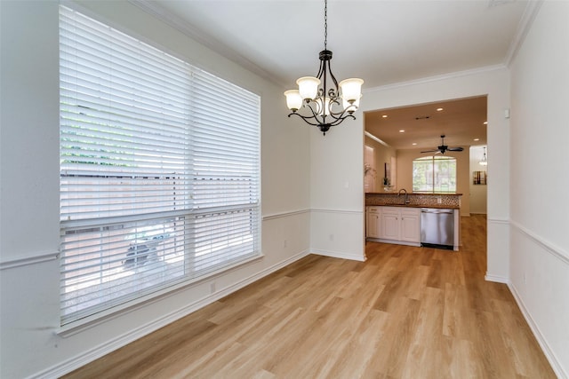 661 Raintree Cir, Coppell, TX 75019 - unfurnished dining area featuring a chandelier, light wood-type flooring, crown molding, and ceiling fan