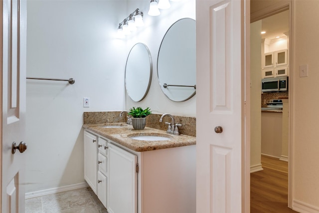 661 Raintree Cir, Coppell, TX 75019 - full bathroom featuring double vanity and tasteful backsplash