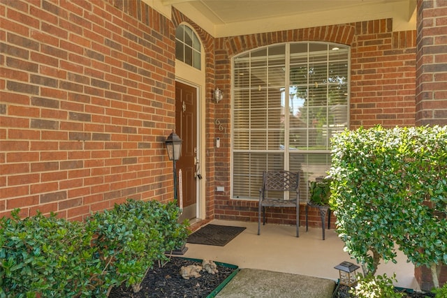 661 Raintree Cir, Coppell, TX 75019 - doorway to property featuring brick siding and covered porch
