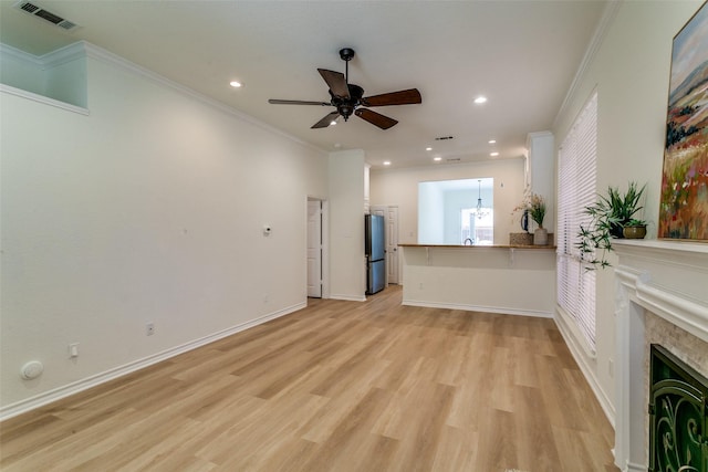 661 Raintree Cir, Coppell, TX 75019 - unfurnished living room with a ceiling fan, light wood-style flooring, recessed lighting, crown molding, and a fireplace