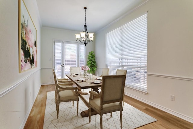 661 Raintree Cir, Coppell, TX 75019 - dining space featuring a chandelier, light wood-style floors, and crown molding