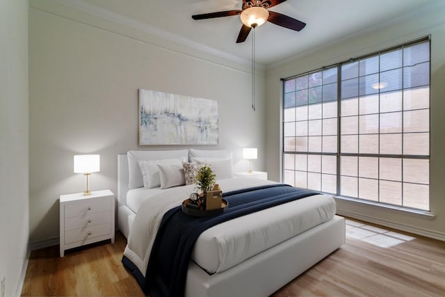 661 Raintree Cir, Coppell, TX 75019 - bedroom featuring wood finished floors, ornamental molding, and a ceiling fan