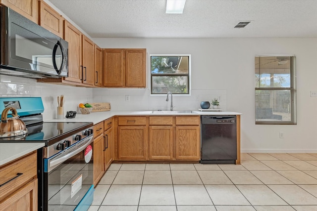 3300 Jacobs Dr, Mckinney, TX 75070 - kitchen with dishwashing machine, stainless steel electric range, black microwave, light countertops, and backsplash